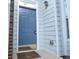 Close-up of a blue front door with brass fixtures and a 'Welcome' mat, set against light gray siding at 2594 Laurel Nw Cir, Atlanta, GA 30311