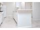 Bright, all-white kitchen with modern appliances, a breakfast bar, and sleek marble floors at 2594 Laurel Nw Cir, Atlanta, GA 30311