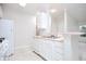 Bright, all-white kitchen featuring modern appliances, a sink with countertop space, and marble-look flooring at 2594 Laurel Nw Cir, Atlanta, GA 30311