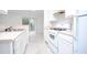 Clean kitchen featuring white cabinets, countertops and appliances and a sliding glass door to the backyard at 2594 Laurel Nw Cir, Atlanta, GA 30311
