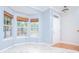 Bright living room with bay window and woven shades, complemented by marble floors and neutral wall color at 2594 Laurel Nw Cir, Atlanta, GA 30311