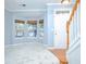 Inviting living room with a staircase, featuring a bay window with woven shades and marble-look flooring at 2594 Laurel Nw Cir, Atlanta, GA 30311