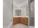 Bright bathroom featuring double sinks, mirrors, and a separate tub and shower at 2594 Laurel Nw Cir, Atlanta, GA 30311