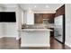 Contemporary kitchen with a central island, stainless steel appliances, and dark cabinetry for a modern feel at 3005 Devoncroft Se St, Smyrna, GA 30080