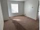 Bedroom with large window, carpet flooring, and natural light at 4232 Marjorie Rd, Snellville, GA 30039