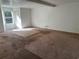 Spacious living room featuring carpet flooring and natural light from large windows at 4232 Marjorie Rd, Snellville, GA 30039