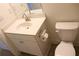 Cozy bathroom featuring white vanity, toilet, mirror, and tiled flooring at 150 Canal St, Hampton, GA 30228