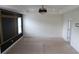 Spacious bedroom featuring neutral carpet, unique black accent wall, and a modern chandelier at 150 Canal St, Hampton, GA 30228