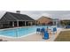 A large community pool is surrounded by lounge chairs and tables with umbrellas at 150 Canal St, Hampton, GA 30228