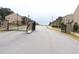 A neighborhood main gate is a metal construction with brick pillars on each side at 150 Canal St, Hampton, GA 30228