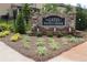 A stone entrance sign welcomes you to The Gates at Pates Creek, surrounded by meticulously maintained landscaping at 150 Canal St, Hampton, GA 30228