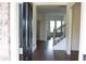 Inviting foyer with hardwood floors and a staircase featuring iron balusters at 150 Canal St, Hampton, GA 30228