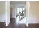 Spacious entry featuring gleaming hardwood floors and a staircase with iron spindles at 150 Canal St, Hampton, GA 30228