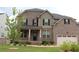 Charming two-story brick home with a well-manicured lawn and inviting front porch at 150 Canal St, Hampton, GA 30228