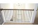 Bright hallway with stairs leading to a front door below, and black metal railings at 150 Canal St, Hampton, GA 30228
