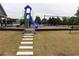 A colorful community playground featuring slides, swings, and a bridge for hours of fun at 150 Canal St, Hampton, GA 30228