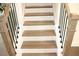 Staircase showcasing wooden treads, white risers, and black iron railing at 150 Canal St, Hampton, GA 30228