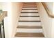 Staircase featuring carpet and wooden handrail at 150 Canal St, Hampton, GA 30228