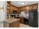 Kitchen with black appliances, granite countertops and wood cabinets at 1500 Pine Log #D Ne Rd, Conyers, GA 30012