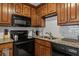 Kitchen with black appliances, granite countertops and white subway tile backsplash at 1500 Pine Log #D Ne Rd, Conyers, GA 30012