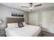 Modern bedroom with a tufted headboard bed, ceiling fan, and double closets at 1500 Pine Log #D Ne Rd, Conyers, GA 30012