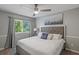 Modern bedroom with a tufted headboard bed, ceiling fan, and a bright window view at 1500 Pine Log #D Ne Rd, Conyers, GA 30012