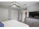 Modern bedroom with a tufted headboard bed, ceiling fan, and dresser at 1500 Pine Log #D Ne Rd, Conyers, GA 30012