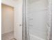 Bright bathroom featuring a shower with bathtub, with a shower curtain and a door leading to another room at 1577 Aiden Way # 39, Conyers, GA 30013