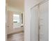 Modern bathroom with a glass walk-in shower and stylish fixtures and a large window at 1577 Aiden Way # 39, Conyers, GA 30013