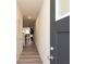 Inviting hallway with modern gray door, leading to an open-concept living area at 1577 Aiden Way # 39, Conyers, GA 30013