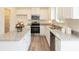 Bright kitchen featuring white cabinets, granite countertops, stainless steel appliances, and a convenient center island at 1577 Aiden Way # 39, Conyers, GA 30013