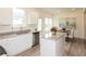 Open kitchen featuring a center island, stainless steel appliances, and a dining area with natural light at 1577 Aiden Way # 39, Conyers, GA 30013