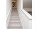 Carpeted staircase leading to the upper level of the home with white railings and neutral walls at 1577 Aiden Way # 39, Conyers, GA 30013