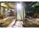 Unfinished basement space with exposed stone foundation, utilities, and stairway leading outside at 1699 Emerald Sw Ave, Atlanta, GA 30310