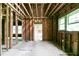 Living room under construction with exposed framing, wood floors, and natural light at 1699 Emerald Sw Ave, Atlanta, GA 30310