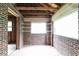 Bright sunroom has brick walls, large windows, and tiled flooring ready for updates at 1699 Emerald Sw Ave, Atlanta, GA 30310