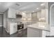 Modern white kitchen with stainless steel appliances, grey tile backsplash, and quartz countertops at 2769 Peachtree Ne Rd # 10, Atlanta, GA 30305