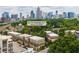 Aerial view of modern townhomes with a beautiful Atlanta skyline backdrop at 384 16Th Nw St # 1, Atlanta, GA 30363