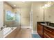 Bathroom featuring double sinks, vanity, granite countertops, and a glass-enclosed shower over a tub at 384 16Th Nw St # 1, Atlanta, GA 30363