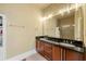 Bathroom with double sink vanity, granite countertops, a large mirror and a glass enclosed shower at 384 16Th Nw St # 1, Atlanta, GA 30363