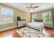 Bedroom with hardwood floors, complemented by natural light from the windows and a ceiling fan at 384 16Th Nw St # 1, Atlanta, GA 30363