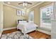 Cozy bedroom featuring a ceiling fan, plush rug, and natural light from two windows at 384 16Th Nw St # 1, Atlanta, GA 30363