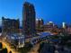 Nighttime cityscape showing modern high-rise buildings in a vibrant urban setting at 384 16Th Nw St # 1, Atlanta, GA 30363
