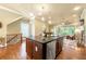 Spacious kitchen island flowing into a cozy living area with a fireplace and backyard views at 384 16Th Nw St # 1, Atlanta, GA 30363