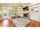 Cozy living room with a stone fireplace, custom built-ins, and large windows providing natural light at 384 16Th Nw St # 1, Atlanta, GA 30363