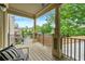Inviting covered porch with outdoor seating and a view of the city skyline at 384 16Th Nw St # 1, Atlanta, GA 30363