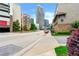 Urban street view featuring modern buildings, lush greenery, and a glimpse of the city skyline at 384 16Th Nw St # 1, Atlanta, GA 30363