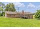 Brick home with a spacious backyard and a deck accessible via stairs at 7928 S Giles Rd, Douglasville, GA 30135