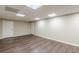 Basement space with wood floors, neutral paint, and two doors at 7928 S Giles Rd, Douglasville, GA 30135