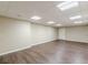 Finished basement with wood-look floors, neutral walls, drop ceiling and plenty of room at 7928 S Giles Rd, Douglasville, GA 30135